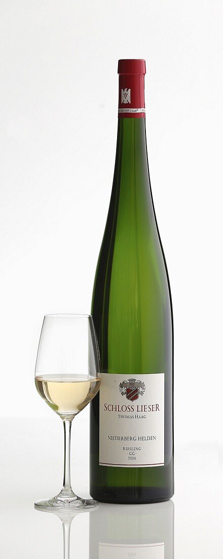 A bottle of white wine and a glass (Schloss Lieser, Magnum, Mosel, Germany)