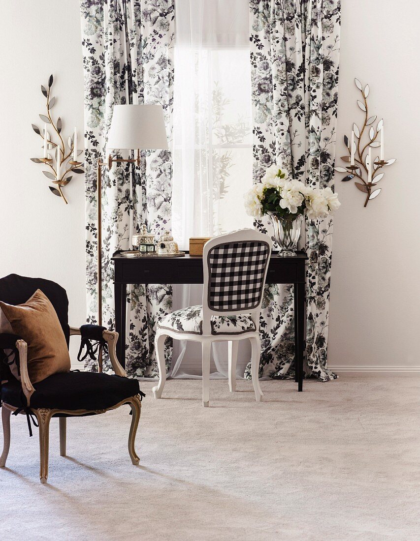 Desk and Baroque chair in front of window with floor-length curtains