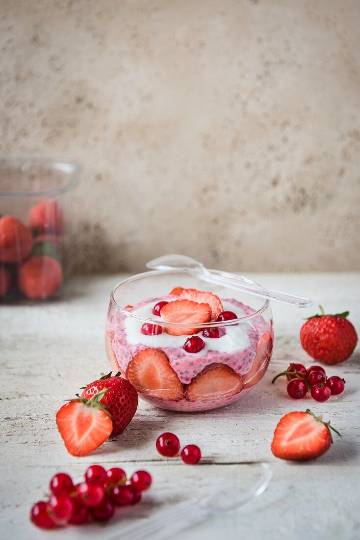 Strawberry-flavoured chia pudding with fresh strawberries and redcurrants