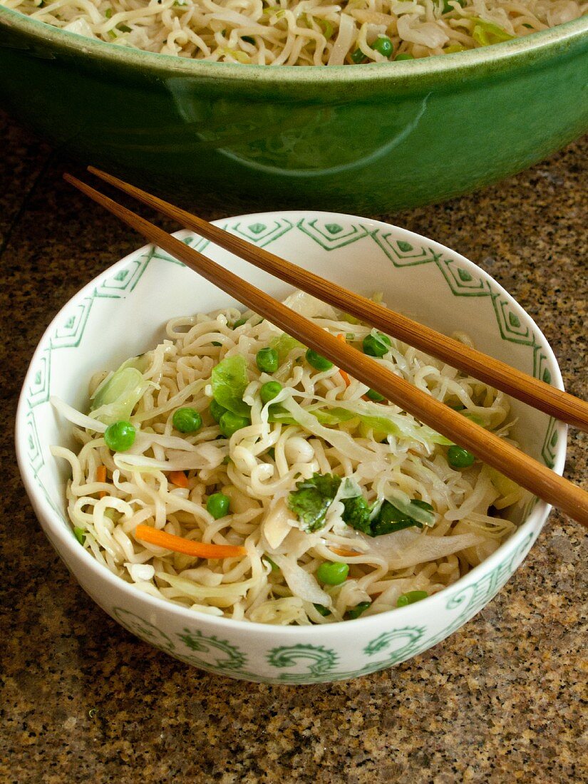 Oriental noodles with vegetables and chopsticks