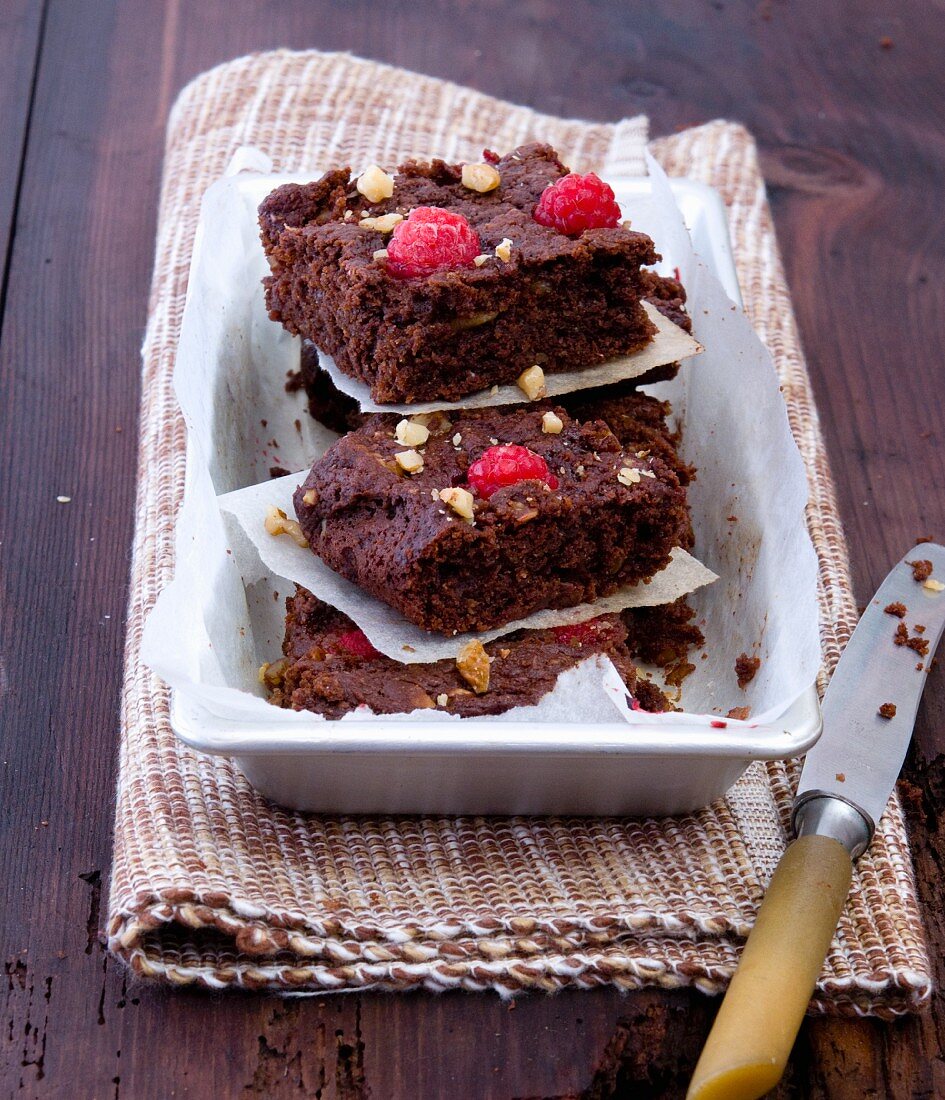 A stack of raspberry brownies with nuts