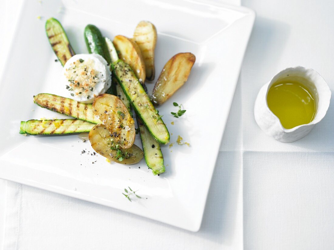 Grilled courgette and new potatoes with goats' cheese medallions