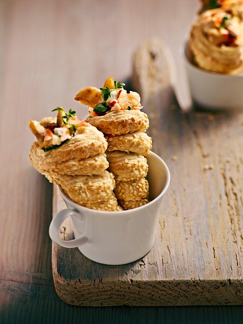 Spiral-shaped puff pastries filled with carrot & chicken salad and coated in sesame seeds