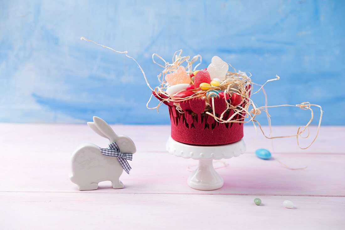 An Easter basket with jelly egg sweets, sugar-coated eggs and foam eggs