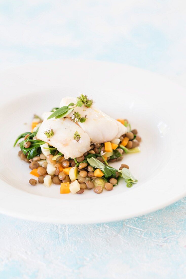 Coalfish with lentils, spinach and vegetables