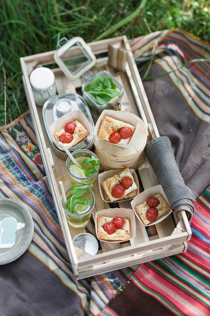 Tomato tartlets in paper cases for a picnic served with lime iced tea
