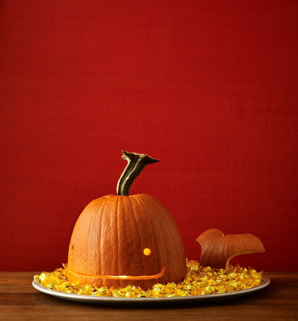 A Halloween pumpkin on a tray carved as a whale