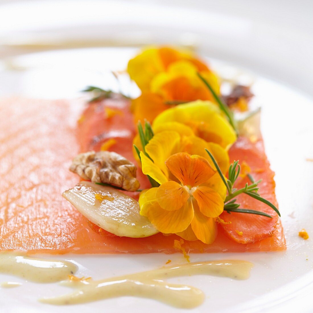 Smoked salmon with walnuts, shallots and yellow edible flowers