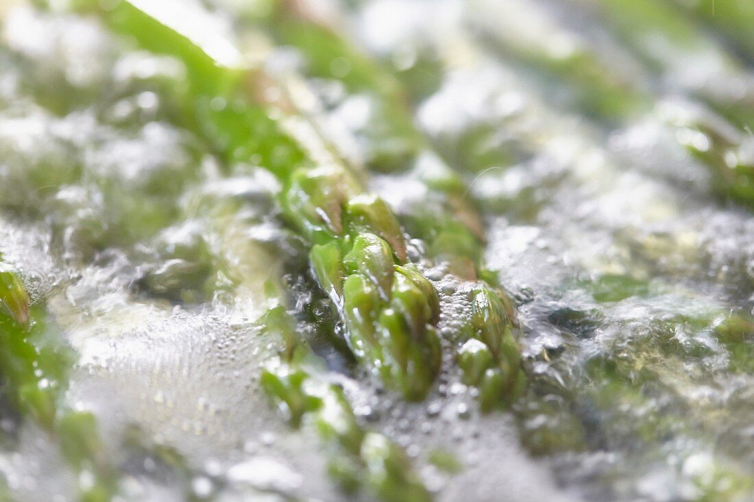 Green asparagus cooking in boiling water