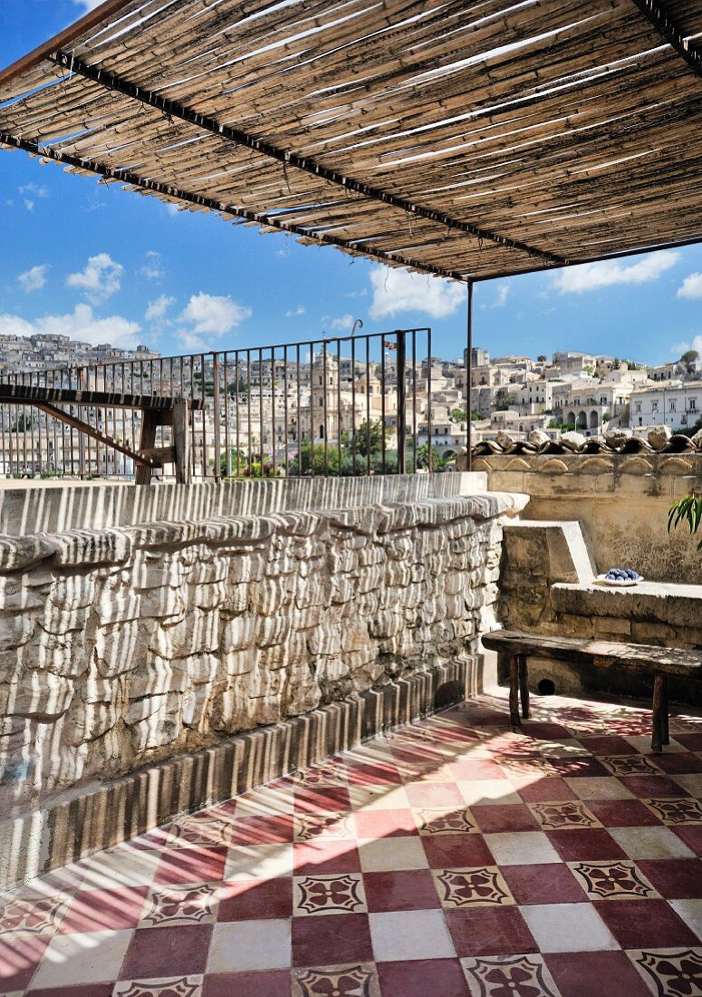 Traditional tiled floor and city view on Mediterranean roof terrace