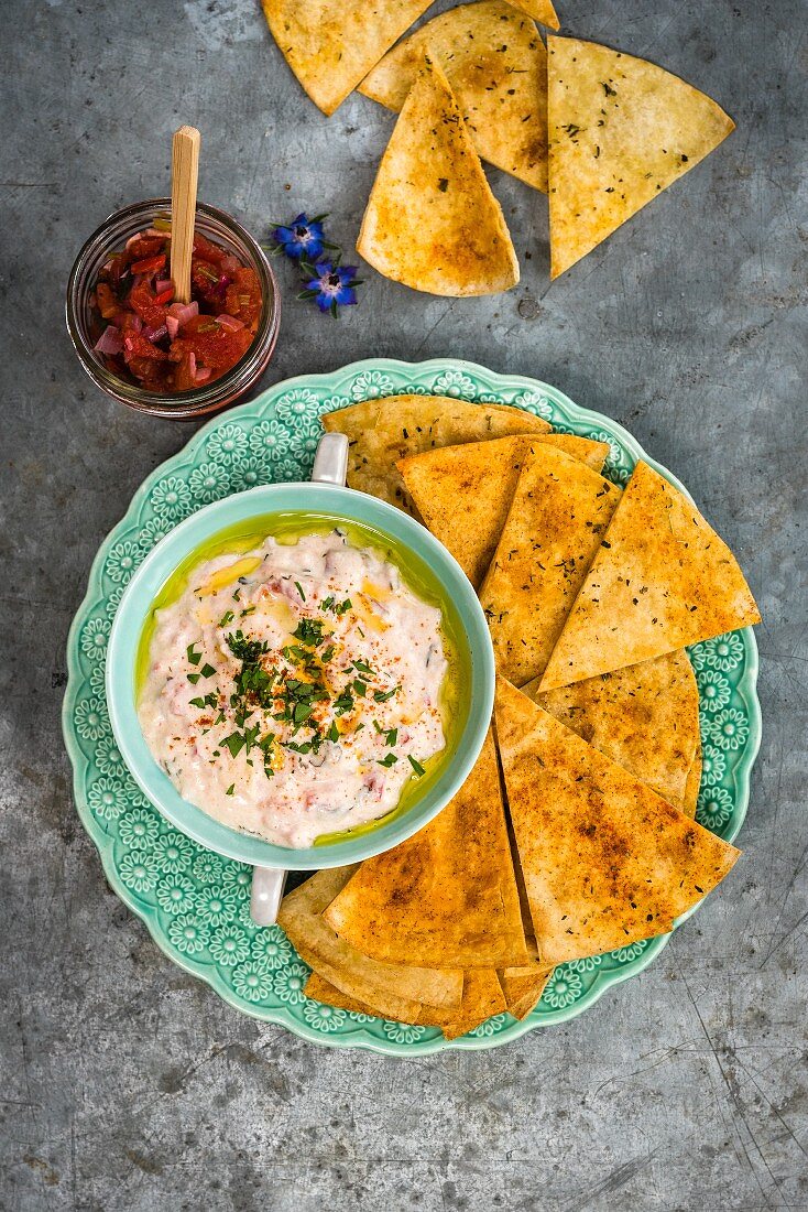 Tortilla chips with a cheese dip and salsa