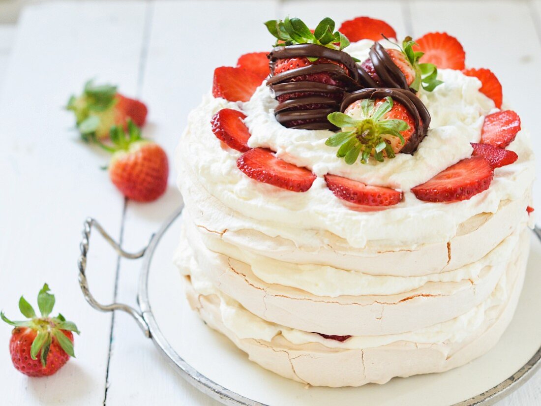 Pavlova with whipped cream and fresh strawberries