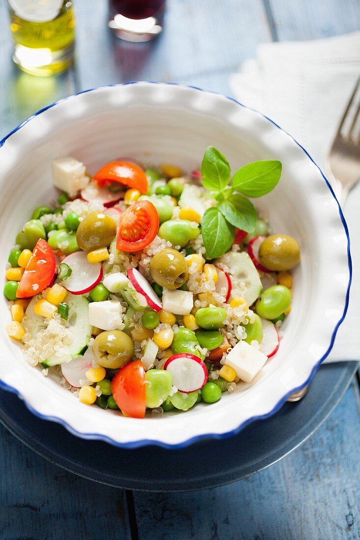 Quinoa salad with vegetables, olives and mozzarella