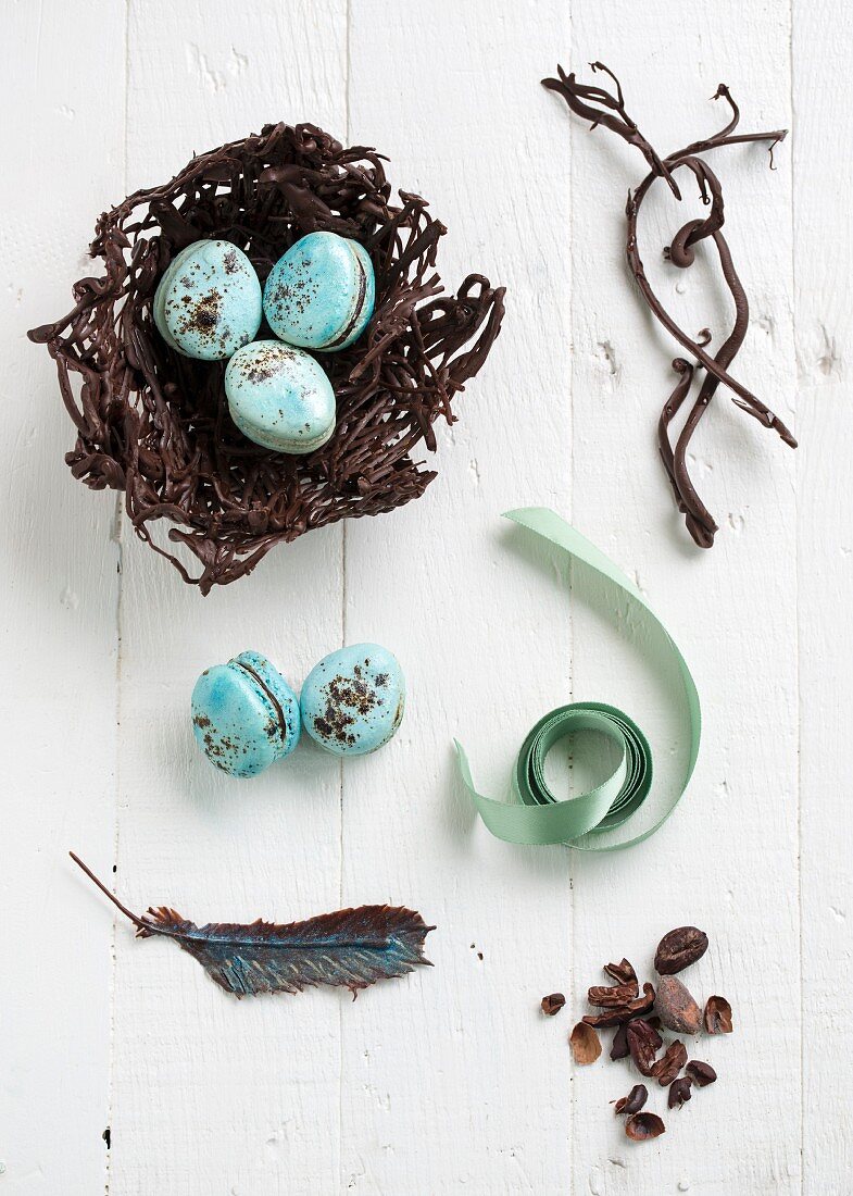 An easter nest with macarons, chocolate feathers and cocoa nibs