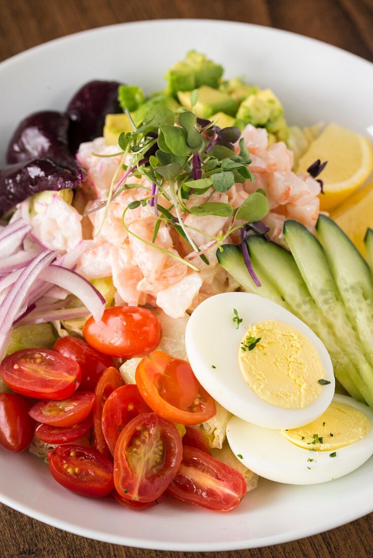 A vegetable salad with shrimps and hard-boiled eggs