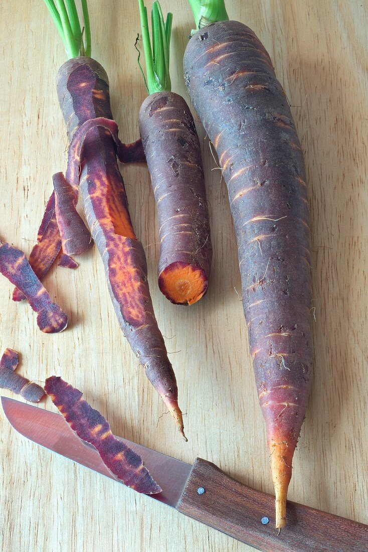 Purple carrots on a chopping board