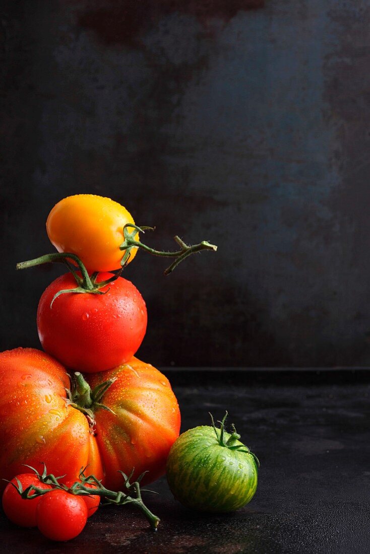 Various tomatoes against a black background
