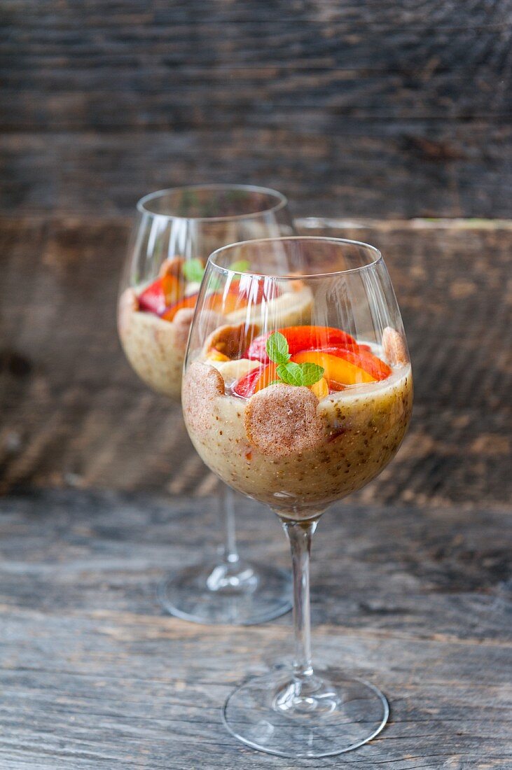 Chia pudding with bananas and nectarines in stemmed glasses
