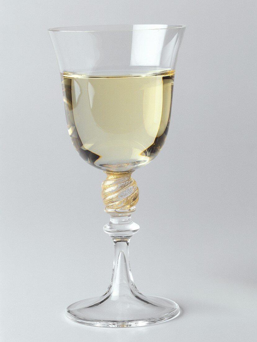 A filled white wine glass