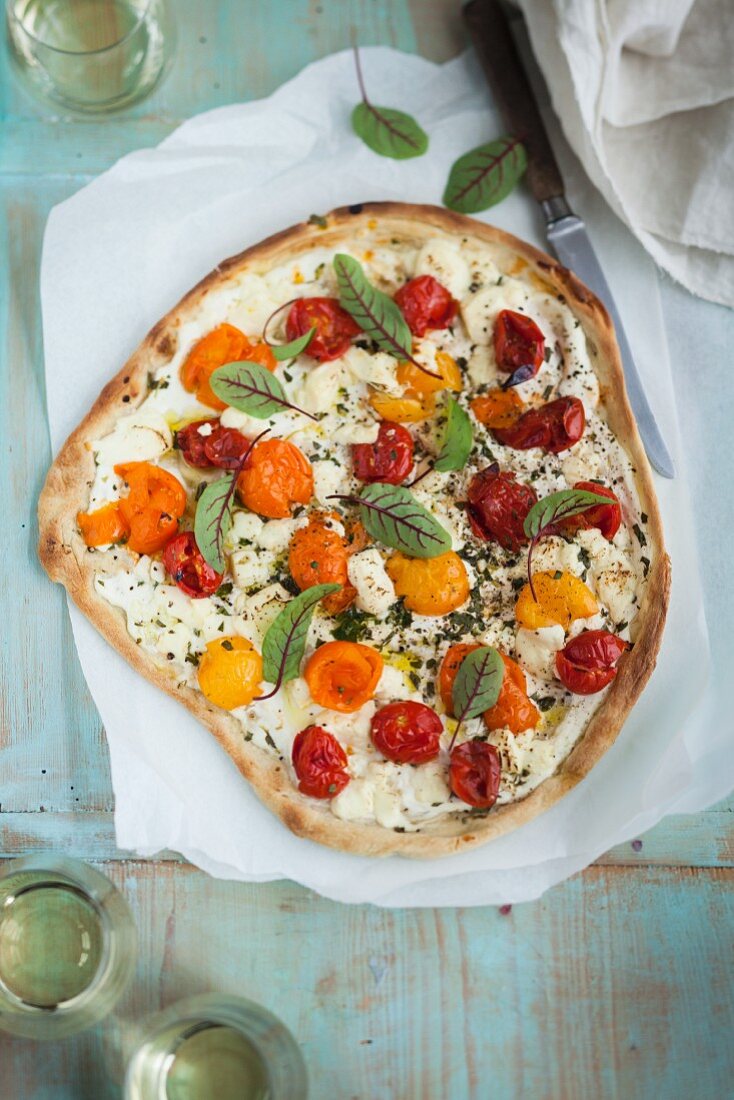 Sheep's cheese pizza with colourful tomatoes