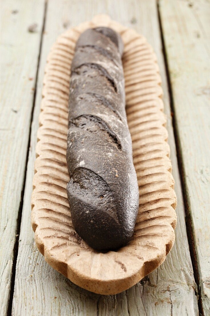 A baguette coloured with squid ink