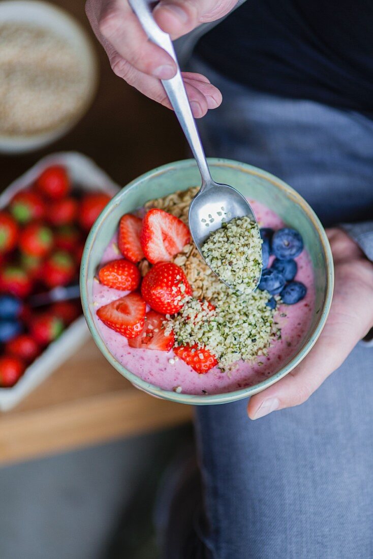 A superfood bowl with strawberries, blueberries, hemp and acai berries
