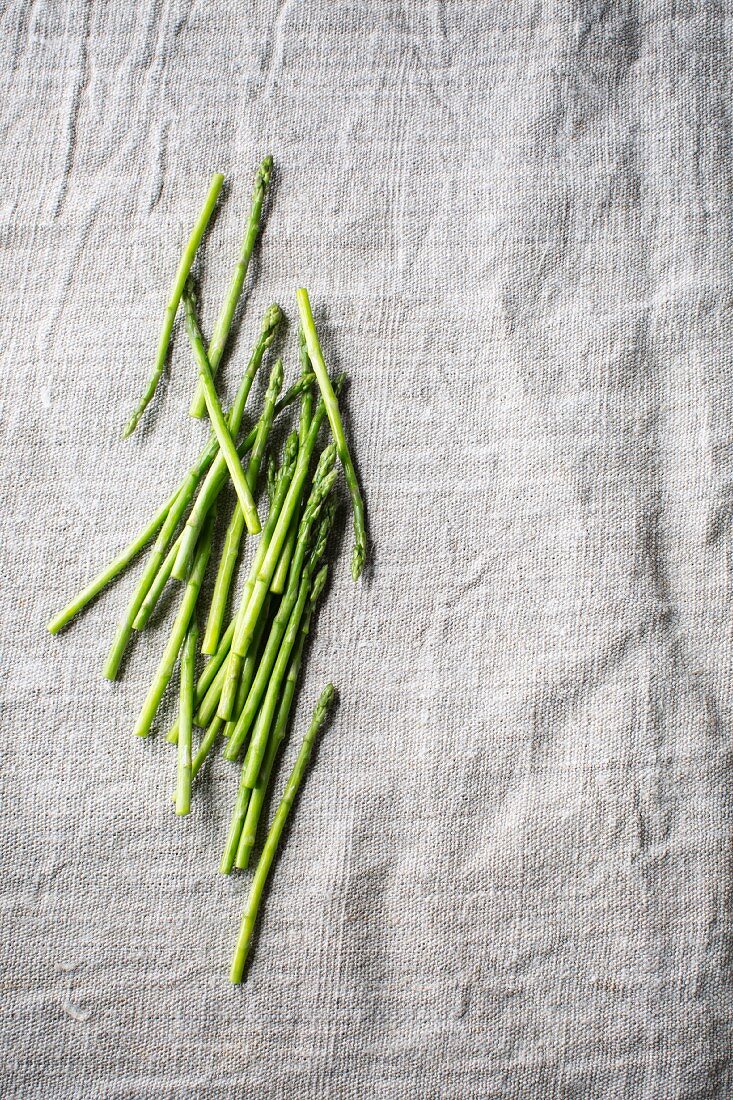 Green asparagus spears on a grey surface