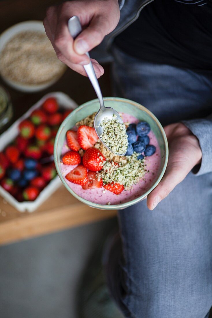 A superfood bowl with strawberries, blueberries, hemp and acai
