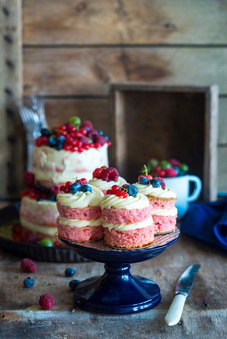 Mini naked cakes with fresh berries on a cake stand