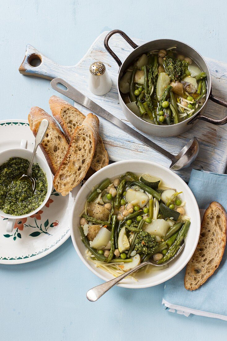 Soup with green beans, asparagus, peas, courgette, potatoes and basil pesto