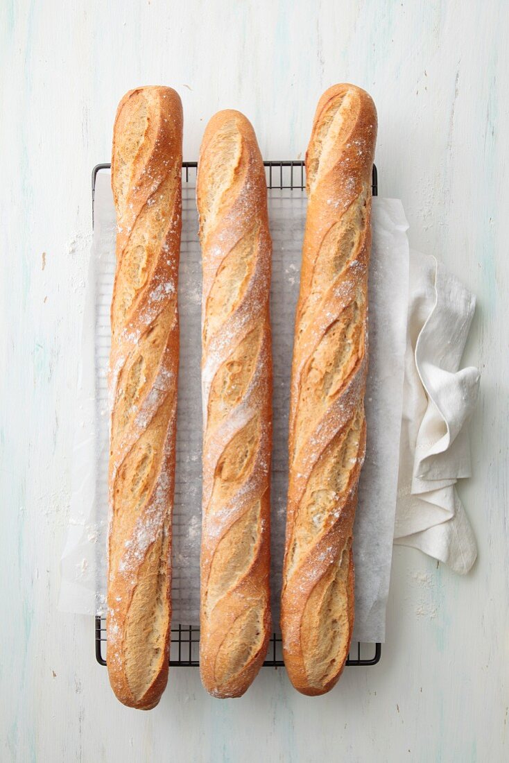 Three baguettes on a cooling rack