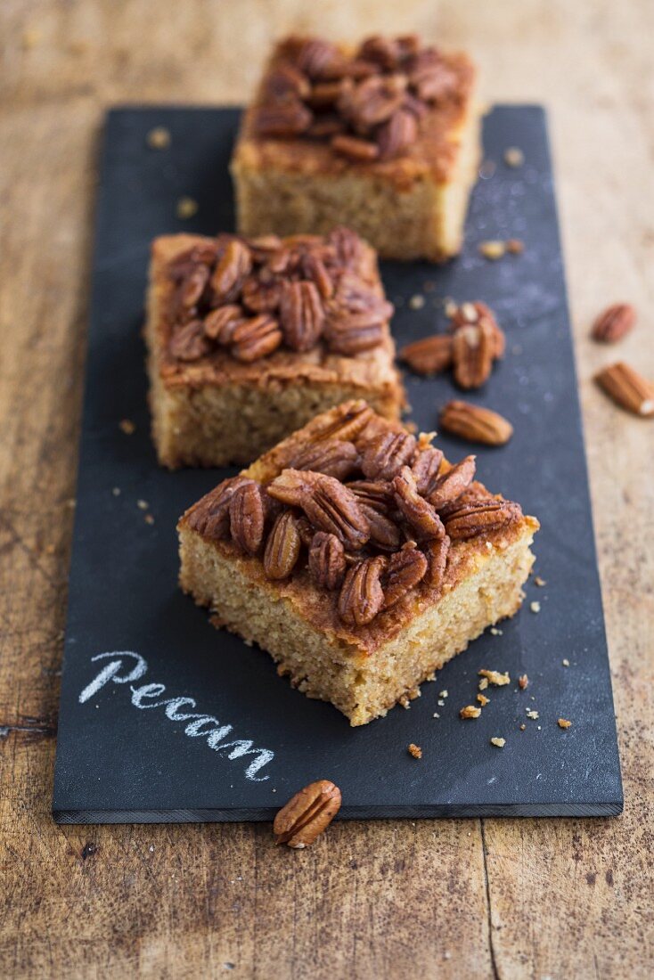 Three slices of pecan nut tray bake cake