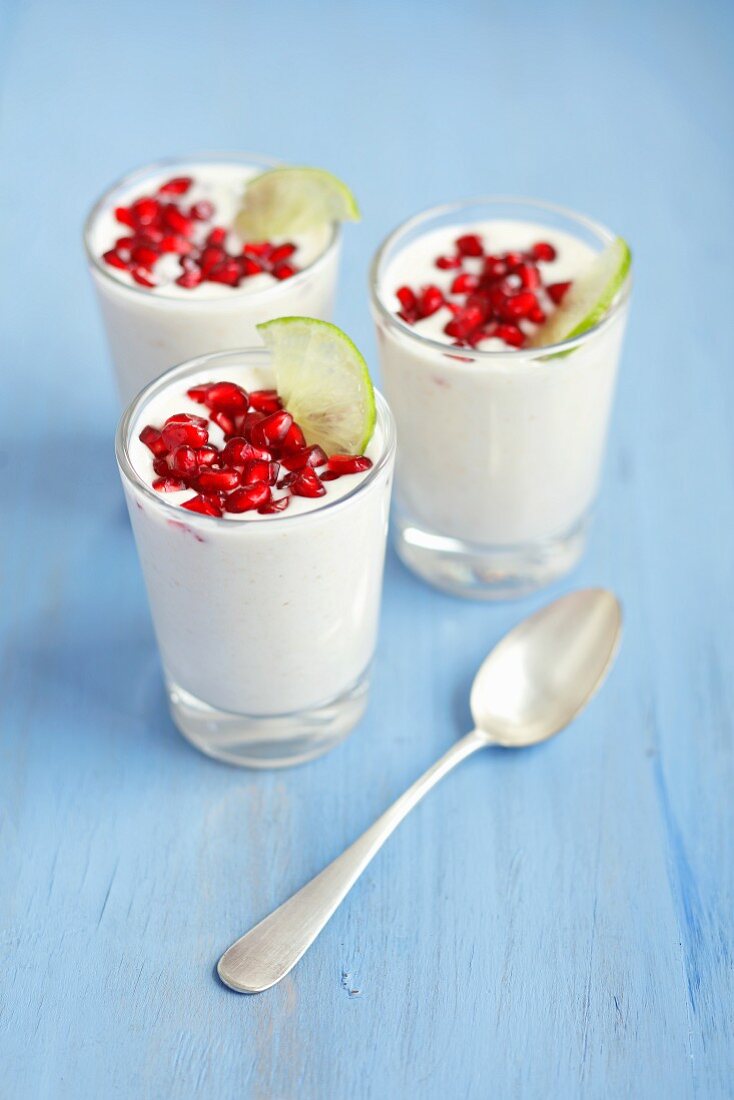 Cocktails with coconut milk, pomegranate seeds and limes