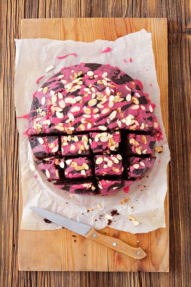 Beetroot brownies with beetroot icing and flaked almonds