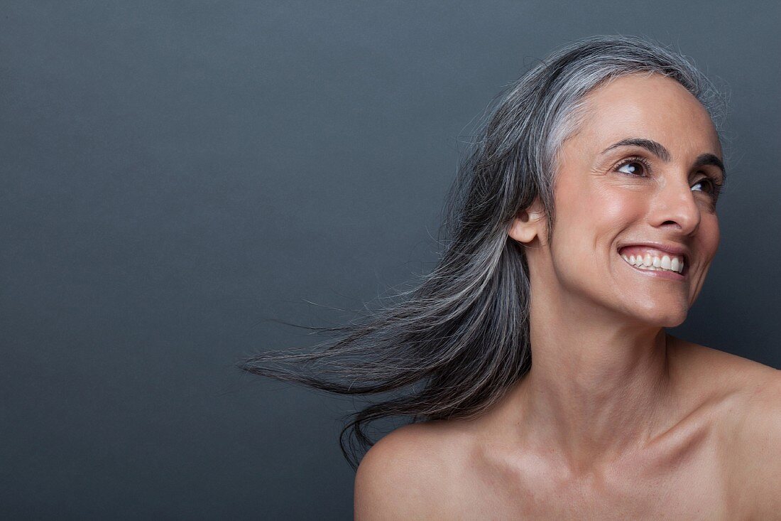 A portrait of an older woman with flowing grey hair