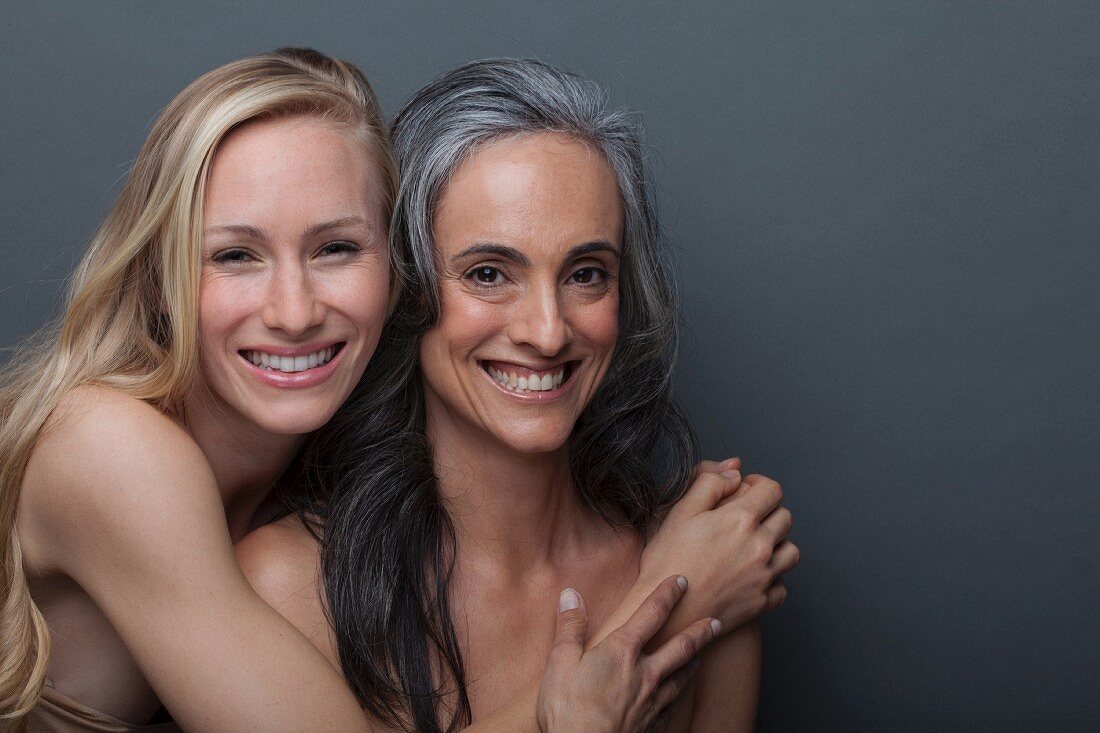 A young woman hugging an older woman