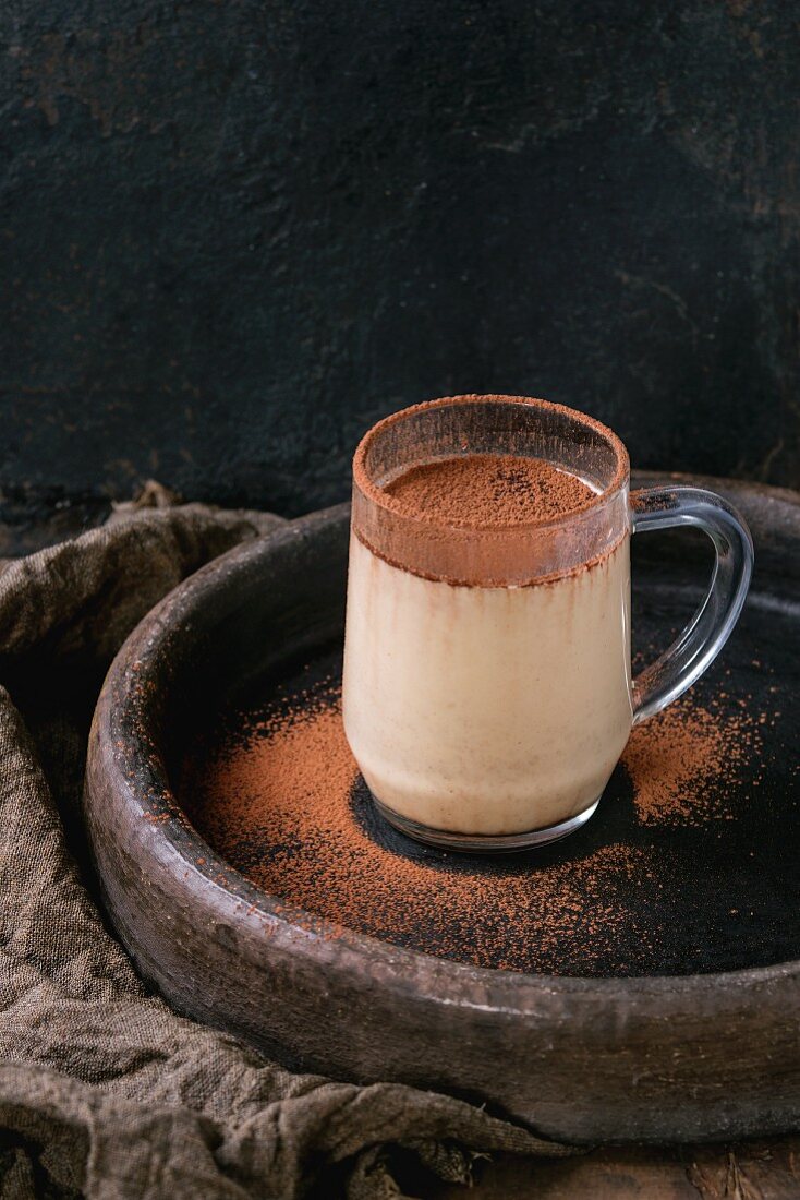 Coconut milk shake with chocolate and cocoa powder in a glass mark