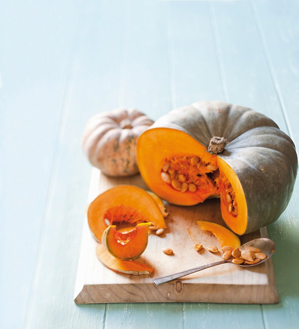 Two sliced pumpkins on a chopping board