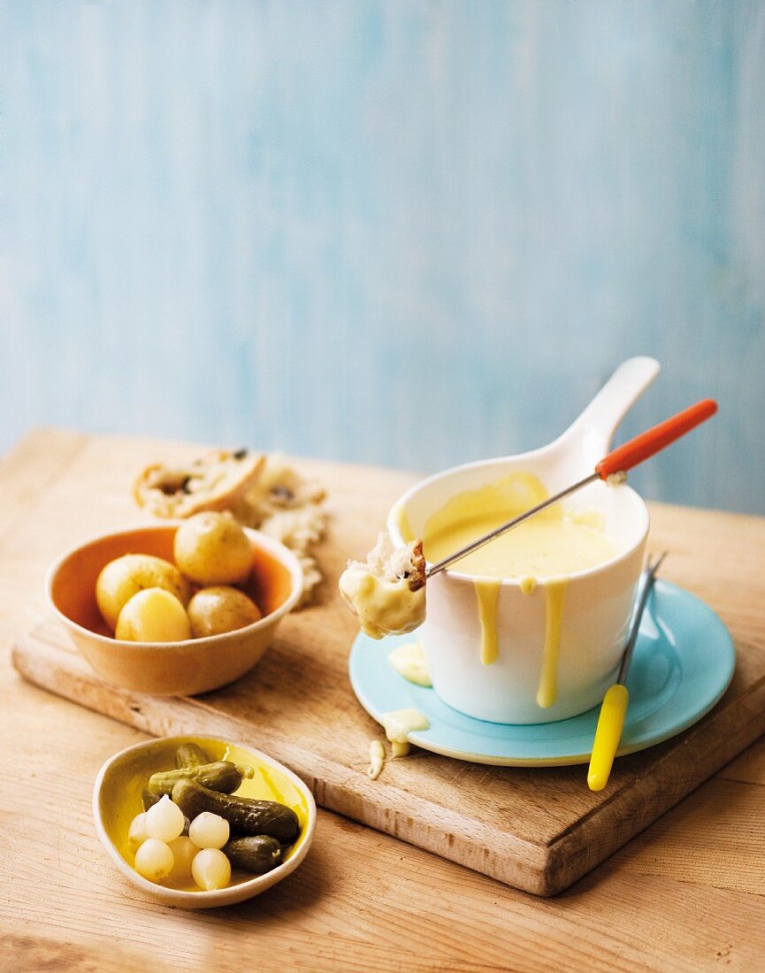 Cheese & wine fondue with bread, potato and gherkins