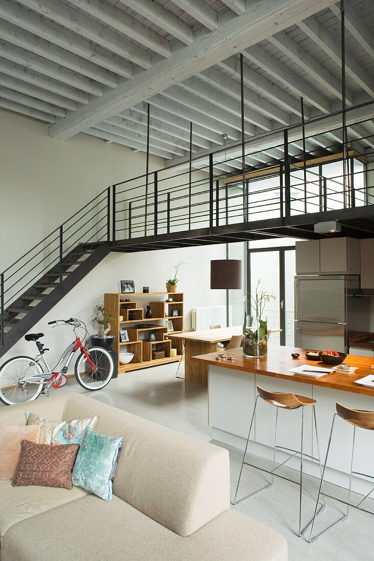 Living area in open-plan loft apartment with mezzanine