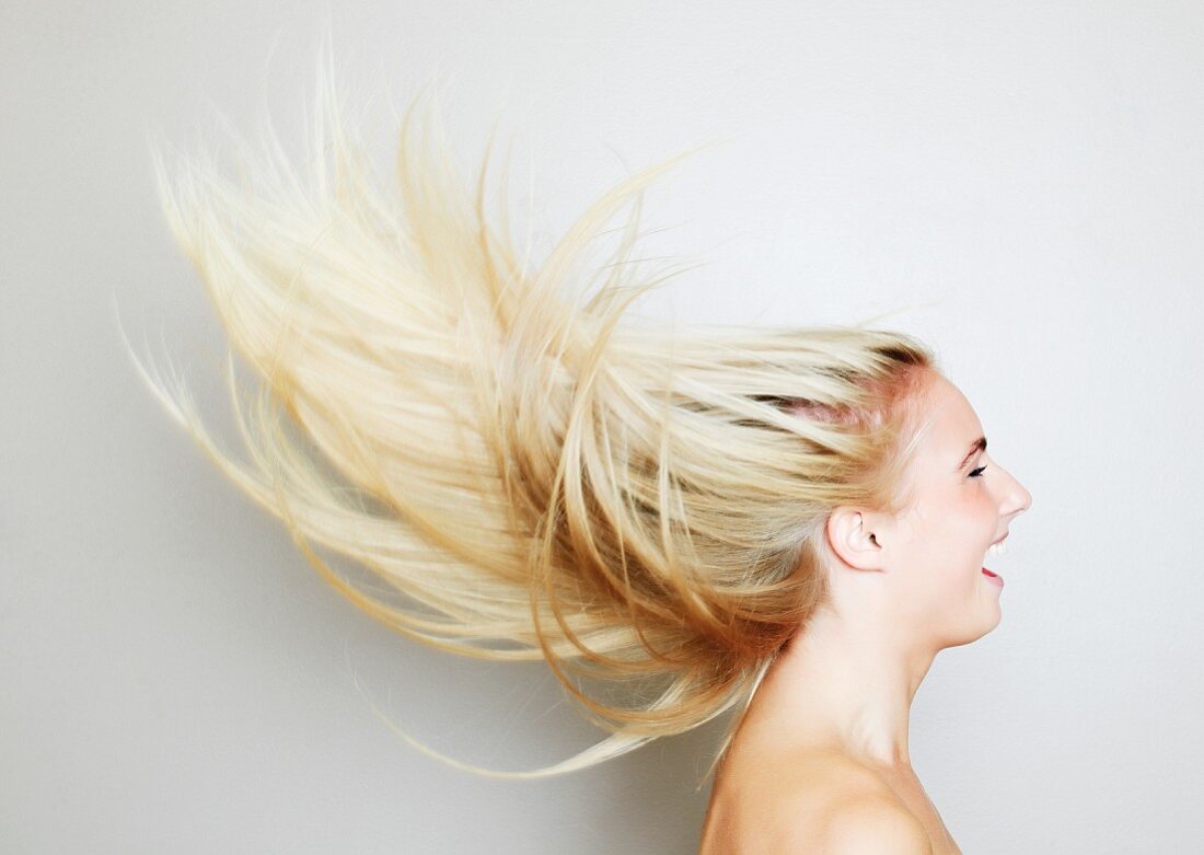A portrait of a blonde woman with the wind in her hair