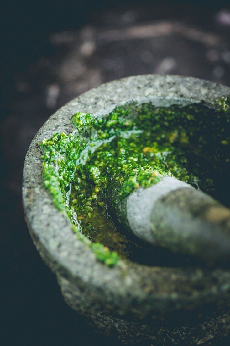 Wild garlic pesto being prepared with a pestle and mortar