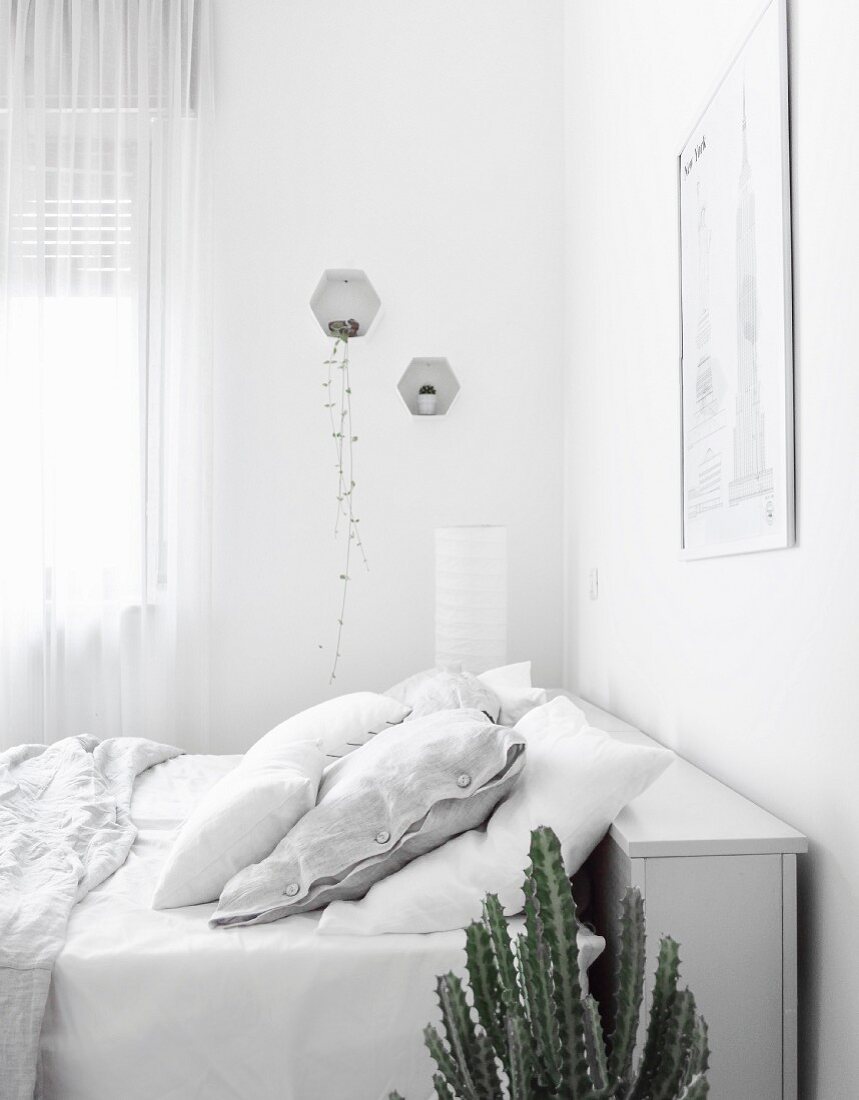 Bed with storage in headboard in white bedroom