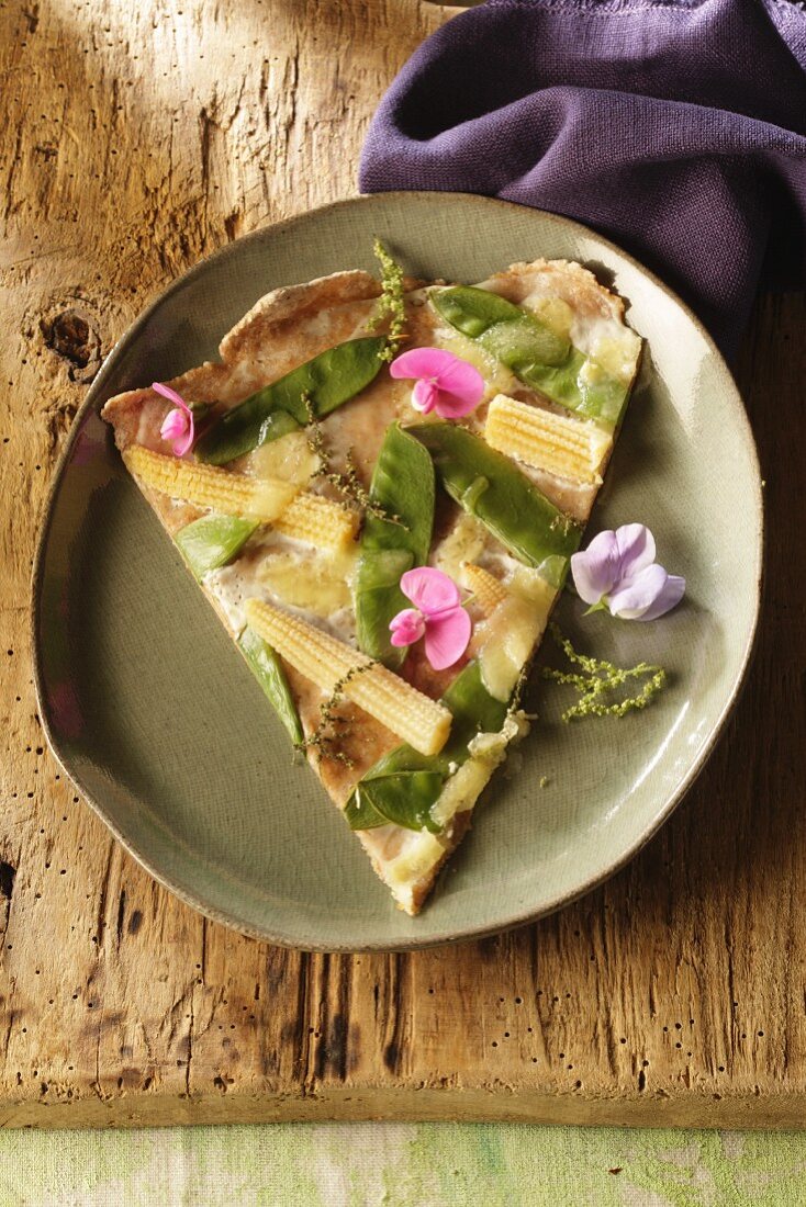 Tarte flambėe with mangetout and mini sweetcorn