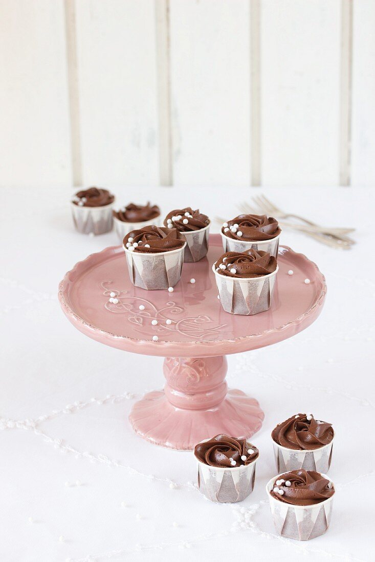 Chocolate cupcakes on a two-tier cake stand