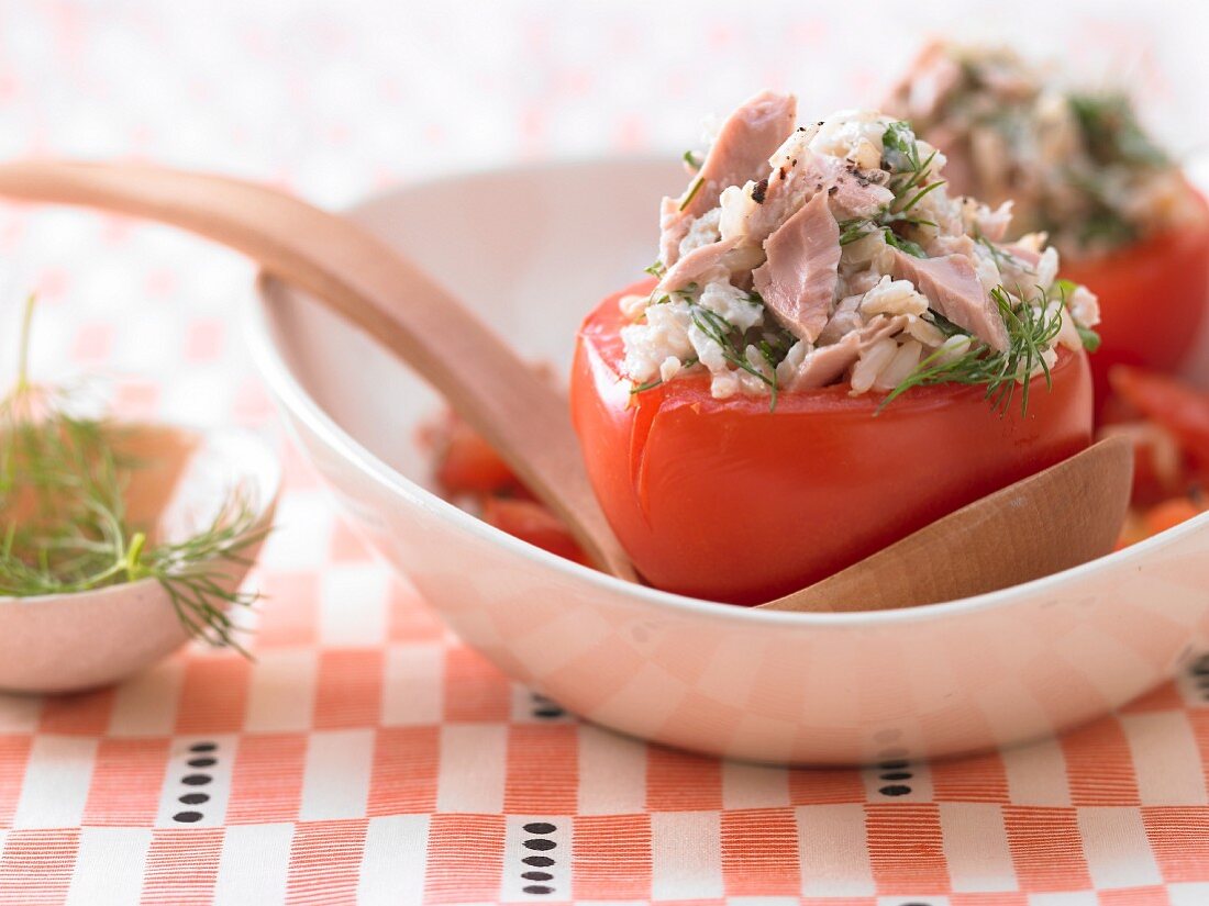 Stewed tomatoes filled with tuna, rice and herbs