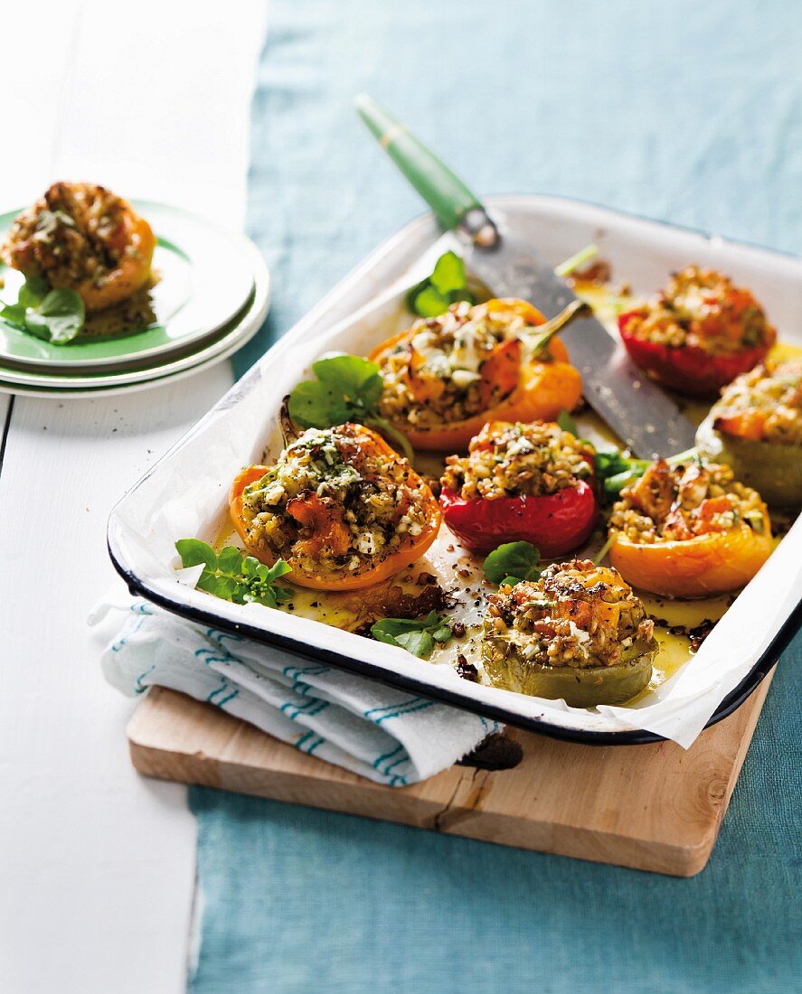 Pepper halves stuffed with roast vegetables, barley and feta cheese
