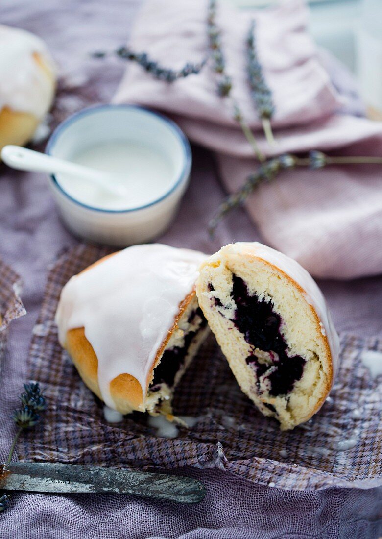 A sweet bun with a berry filling and icing