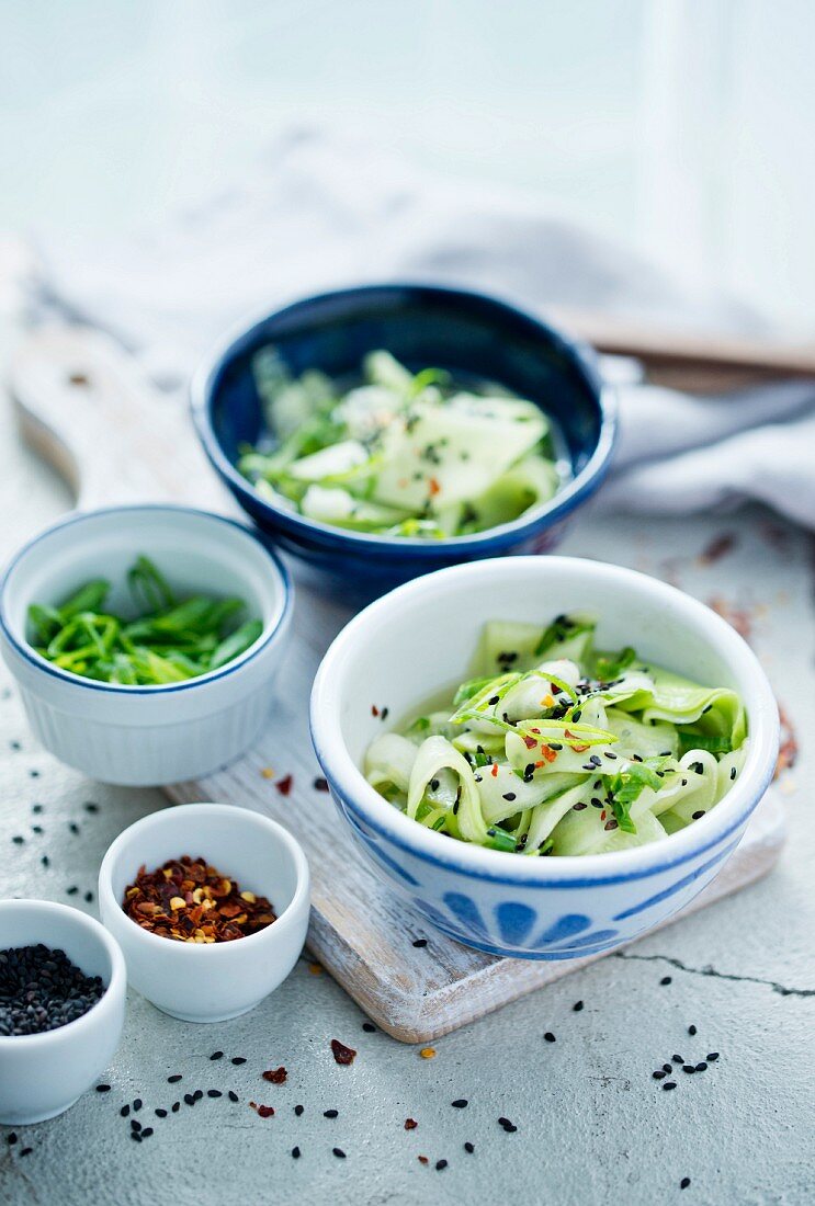 Cucumber salad with chilli flakes, spring onion and sesame seeds