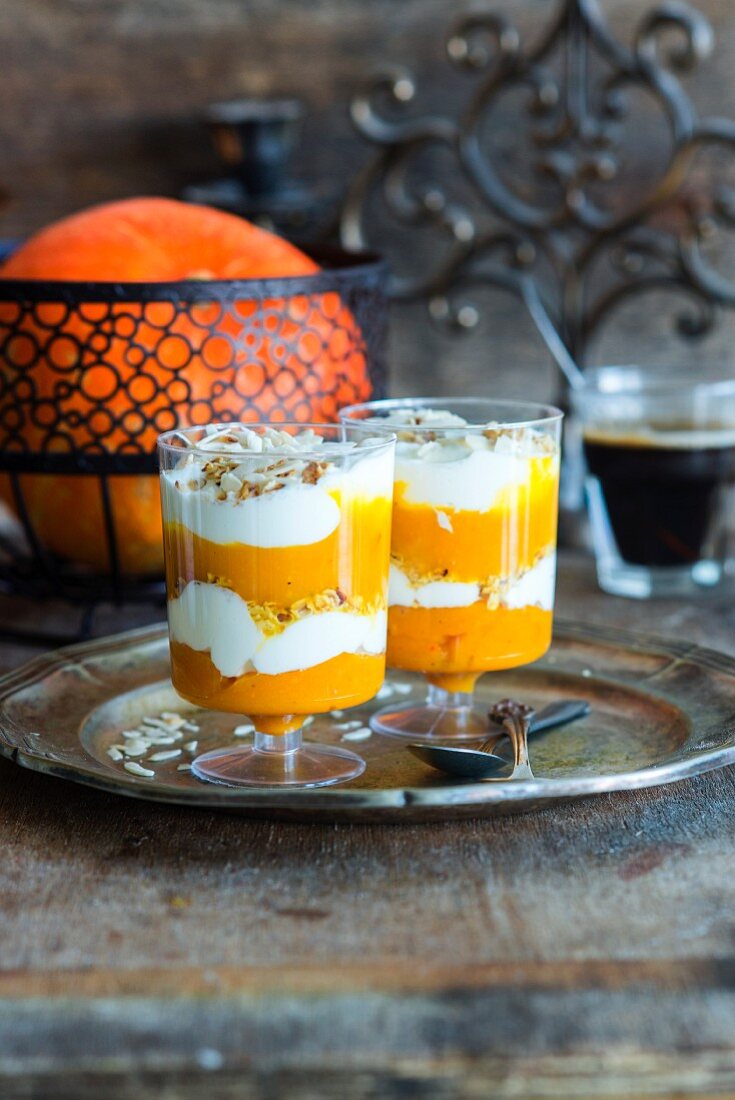 Layred dessert with pumpkin puree, yoghurt and muesli in two glasses